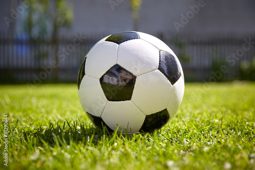 Football of soccer game lying on the grass of the garden