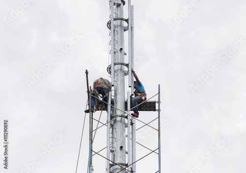 Selangor Malaysia May 21 2016 Riggers Are Working At Top Of The Monopole For Installing Scaffolding Before Radio Frequency Antenna And Microwave Dish Installation Stock Photo Adobe Stock