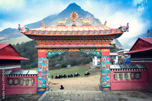 Gate Tengboche monastery in Nepal with the sacred wheel of Dharma and deer on them