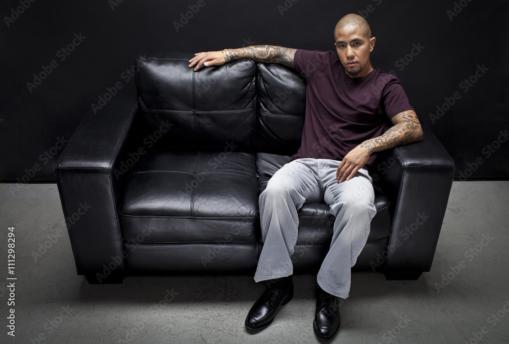 portrait of a african american man sitting on a couch. portrait of a african american man sitting on a couch.