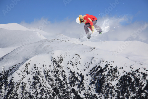 Canvas Print Snowboard rider jumping on mountains