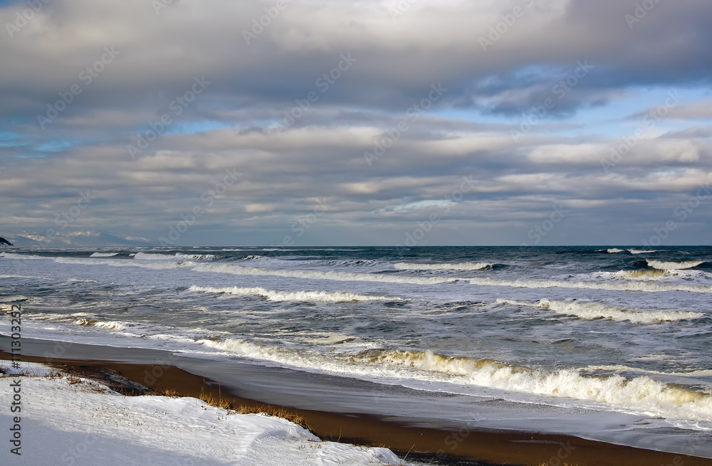 Winter sea shore, snow on the sand