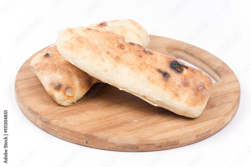 Turkey somun bread on the kitchen cuting wooden board Turkey somun bread on the kitchen cuting wooden board