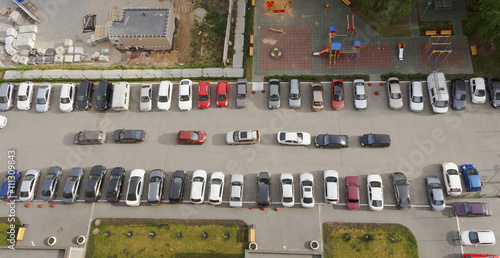 Cars parked in front of high-rise building.The view from the top.