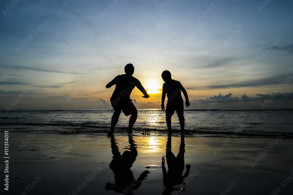 Fototapeta premium boys jumping on the beach Sunset