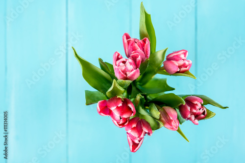 Wet Pink Tulip Flowers In Vase On Turquoise Table