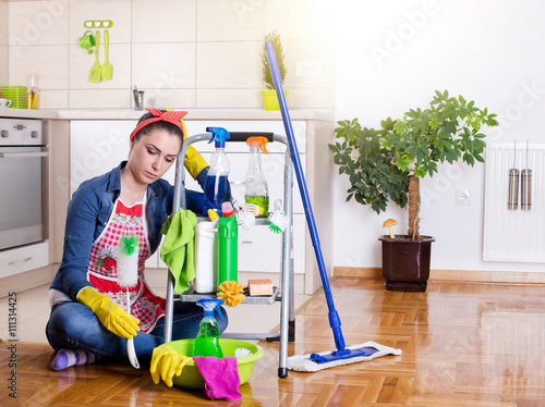 Tired and unhappy cleaning lady