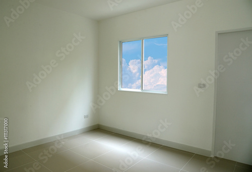 Blue sky seen through window of empty room white space