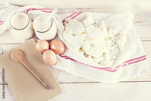 natural yoghurt in a glass jar, eggs and cheese. ingredients for baking