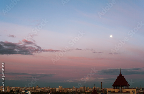 A City Cloudscape with Moon in Evening