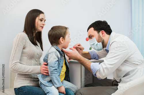 Mother with son during medical appointment, horizontal