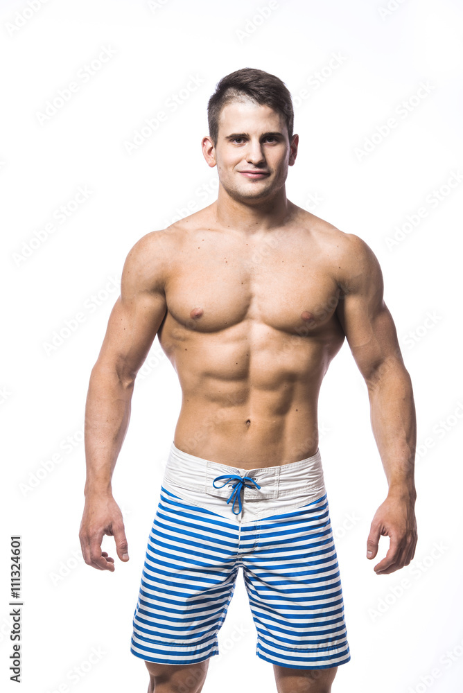 Fototapeta premium Sexy athletic man showing muscular body and sixpack abs, isolated over white background. Strong male nacked torso