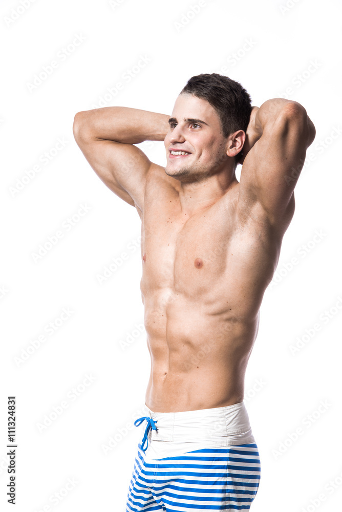 Portrait of a handsome young muscular man in swimwear with hands folded over his head isolated looking up on white background Portrait of a handsome young muscular man in swimwear with hands folded over his head isolated looking up on white background