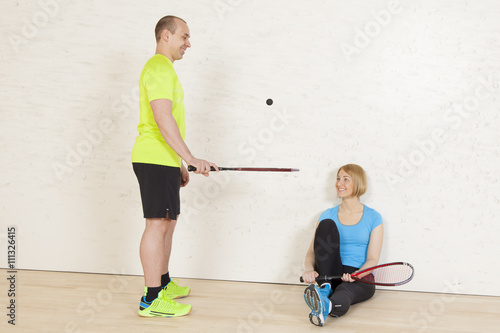 caucasian man and woman on the squash court