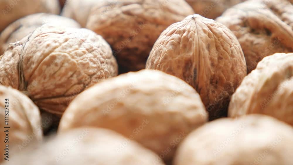 Walnut fruit pieces arranged on the table slow tilt 4K 2160p 30fps UltraHD video - Raw food background of seed of drupaceous nut 4K 3840X2160 UHD tilting footage Walnut fruit pieces arranged on the table slow tilt 4K 2160p 30fps UltraHD video - Raw food background of seed of drupaceous nut 4K 3840X2160 UHD tilting footage