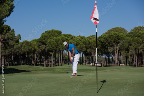 golf player hitting shot at sunny day