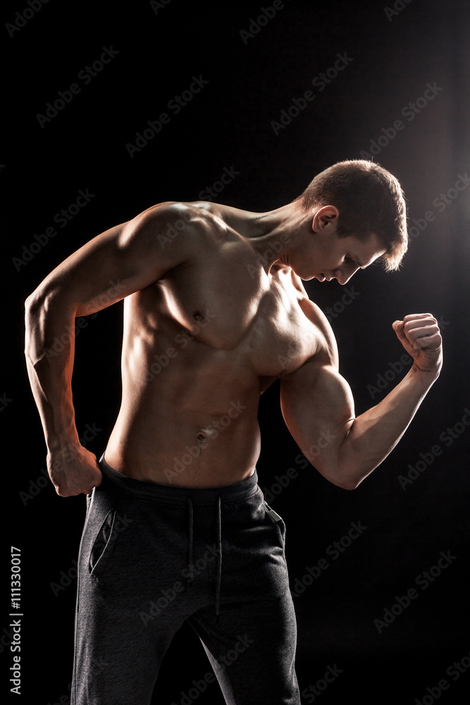 Strong man showing perfect abs, houlders, biceps, triceps and ch Strong man showing perfect abs, houlders, biceps, triceps and ch