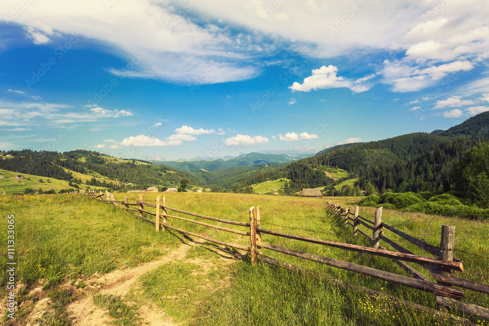 Summer landscape in mountains and the dark blue sky with clouds. Retro color.