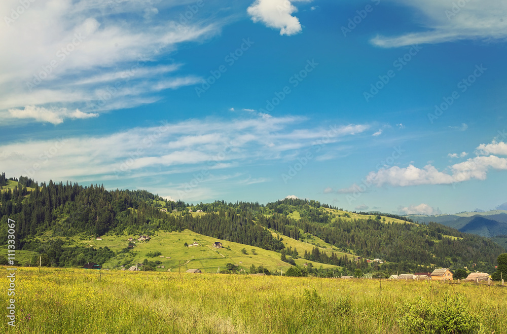 Summer landscape in mountains and the dark blue sky with clouds. Retro color.
