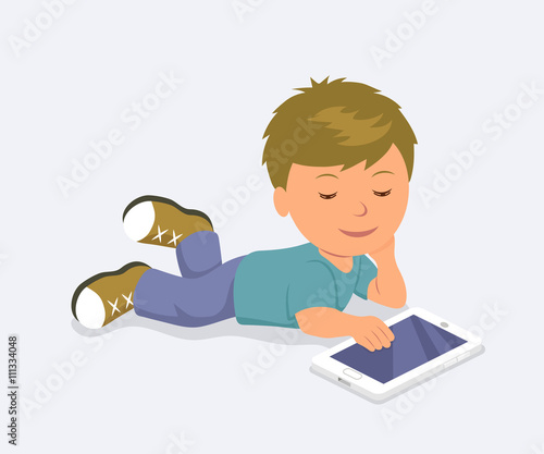 Baby lying down playing mobile games on the tablet. Learning, education and communication on the Internet using a mobile PC.