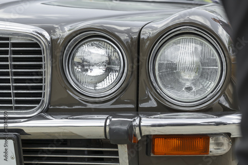 headlight and radiator front view of a retro car