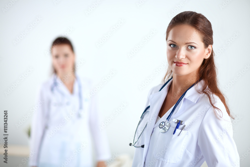 Smiling female doctor with a folder in uniform standing at hospital Smiling female doctor with a folder in uniform standing at hospital