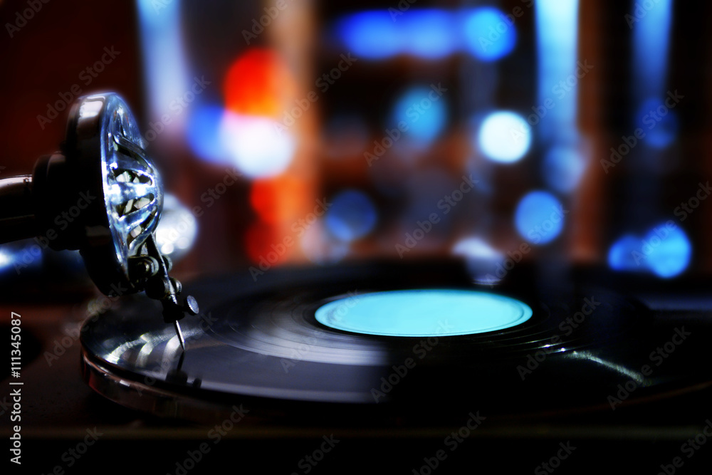 Turntable with vinyl record on dark blurred background Turntable with vinyl record on dark blurred background