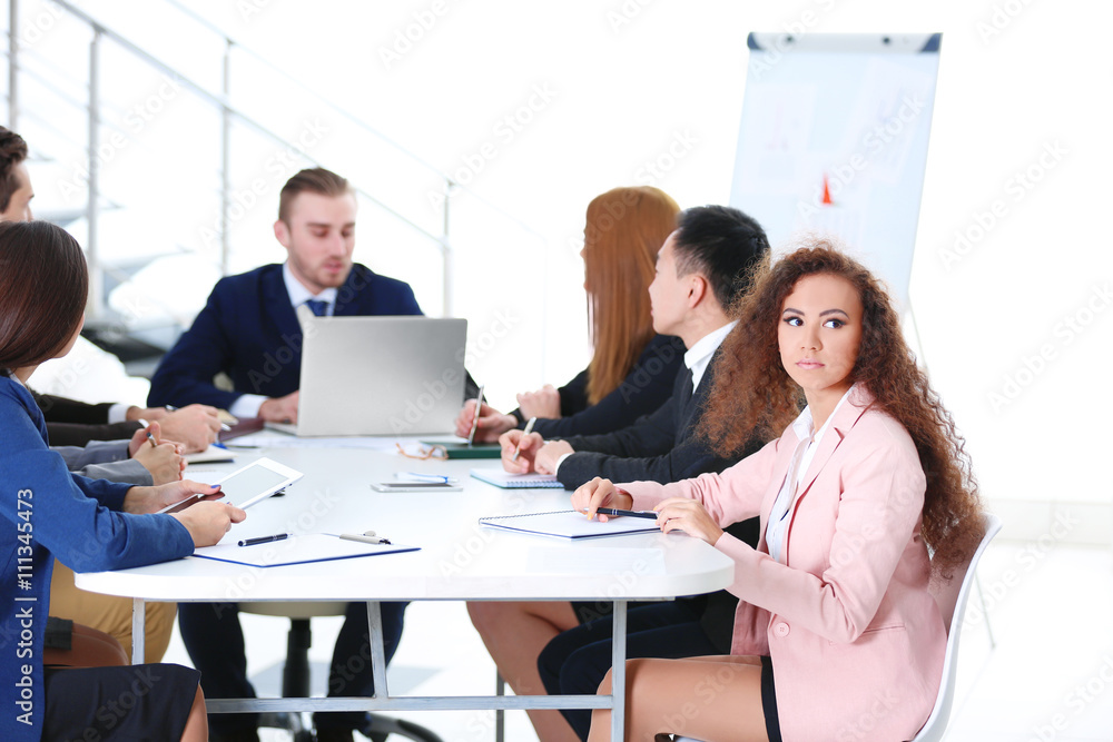 Young colleagues sitting at the business meeting in the office Young colleagues sitting at the business meeting in the office