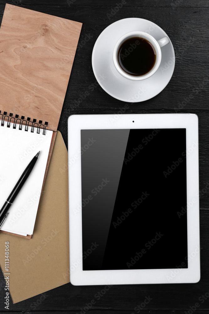 Digital tablet with cup of coffee and notebook on wooden table, closeup Digital tablet with cup of coffee and notebook on wooden table, closeup