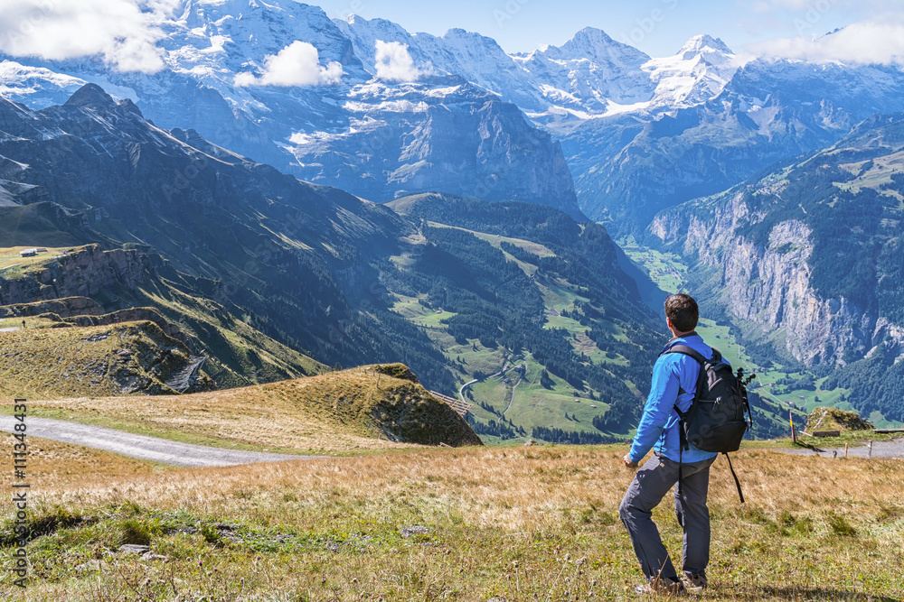 Hiker enjoying the spectacular view in the heart of Swiss alps