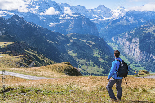 Hiker enjoying the spectacular view in the heart of Swiss alps