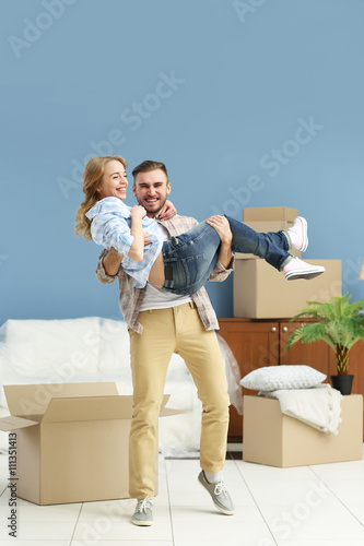 Happy young couple moving i...