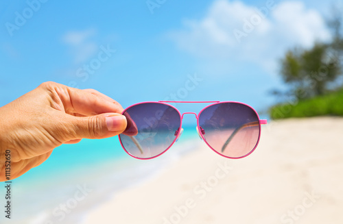 Hand holding Pink Sunglasses