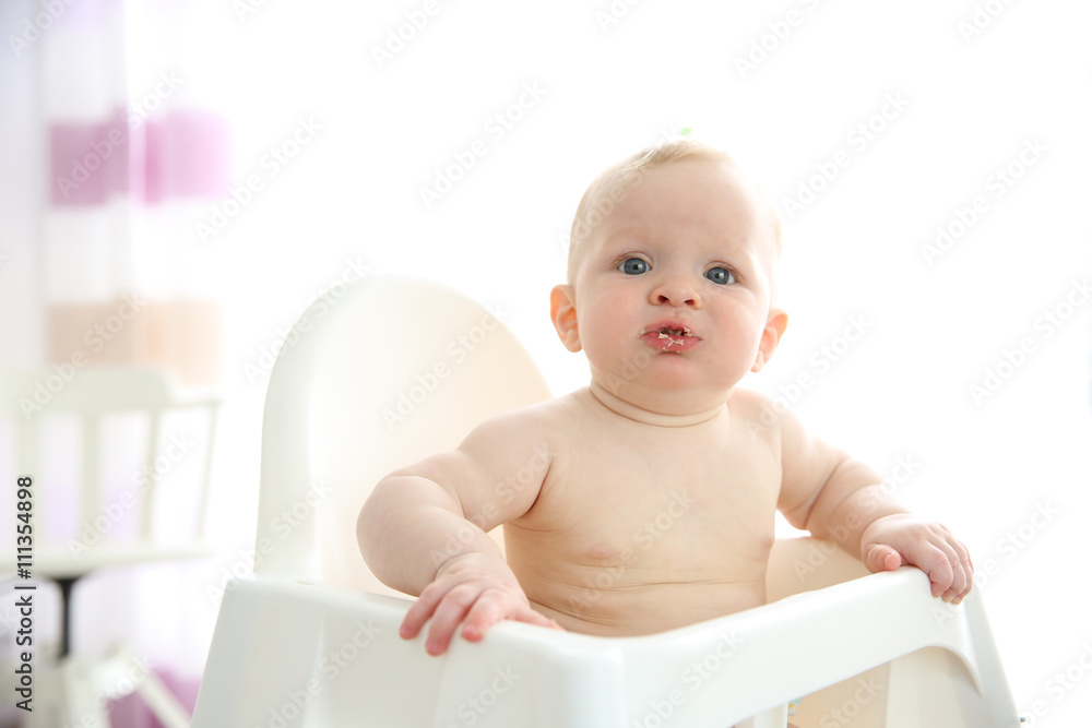 Baby boy sitting in chair and eating. Baby boy sitting in chair and eating.