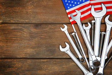 Different kinds of wrenches on a wooden background. Labor day concept.