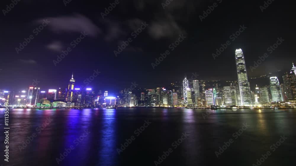 Night view of Hong Kong victoria harbour with ferry going across the harbour quickly Night view of Hong Kong victoria harbour with ferry going across the harbour quickly