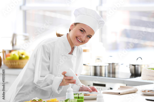 Female chef working at kitchen