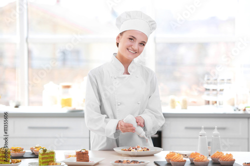 Female chef working at kitchen