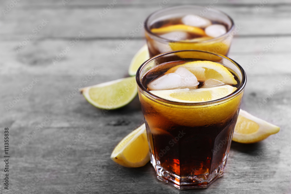 Glasses of soda water with sliced lemon on wooden table Glasses of soda water with sliced lemon on wooden table