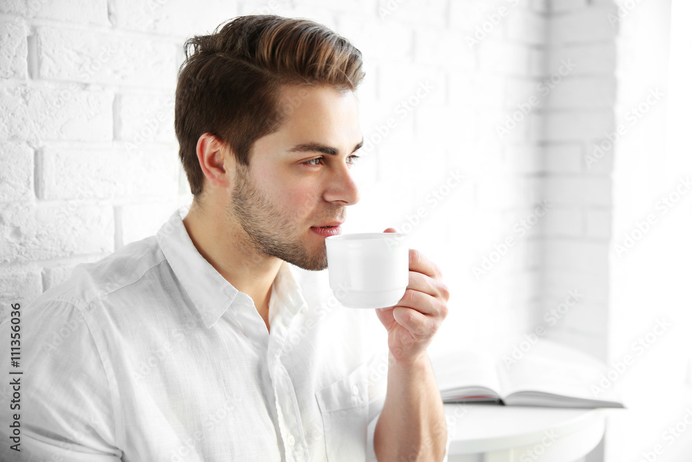 Young man drinking tasty coffee in the morning Young man drinking tasty coffee in the morning