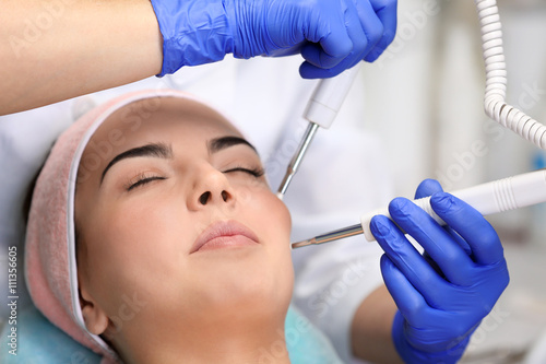 Young woman having face pro...