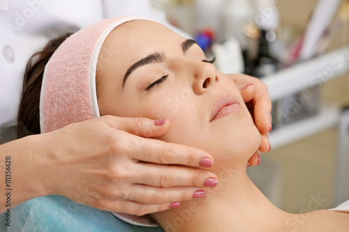 Young woman having face mas...