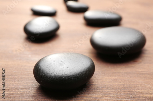Heap of spa hot stones  on wooden background
