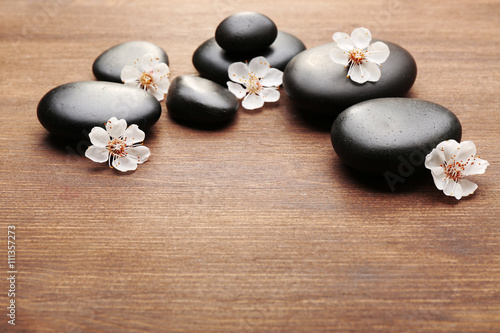 Heap of spa hot stones on wooden background