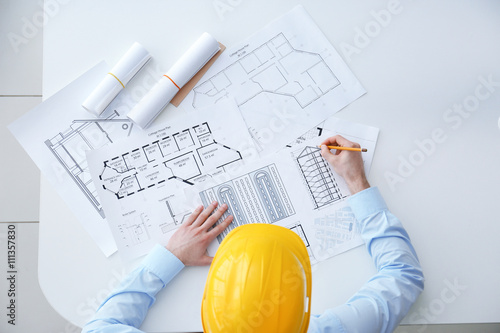 Young male construction engineer working in the office
