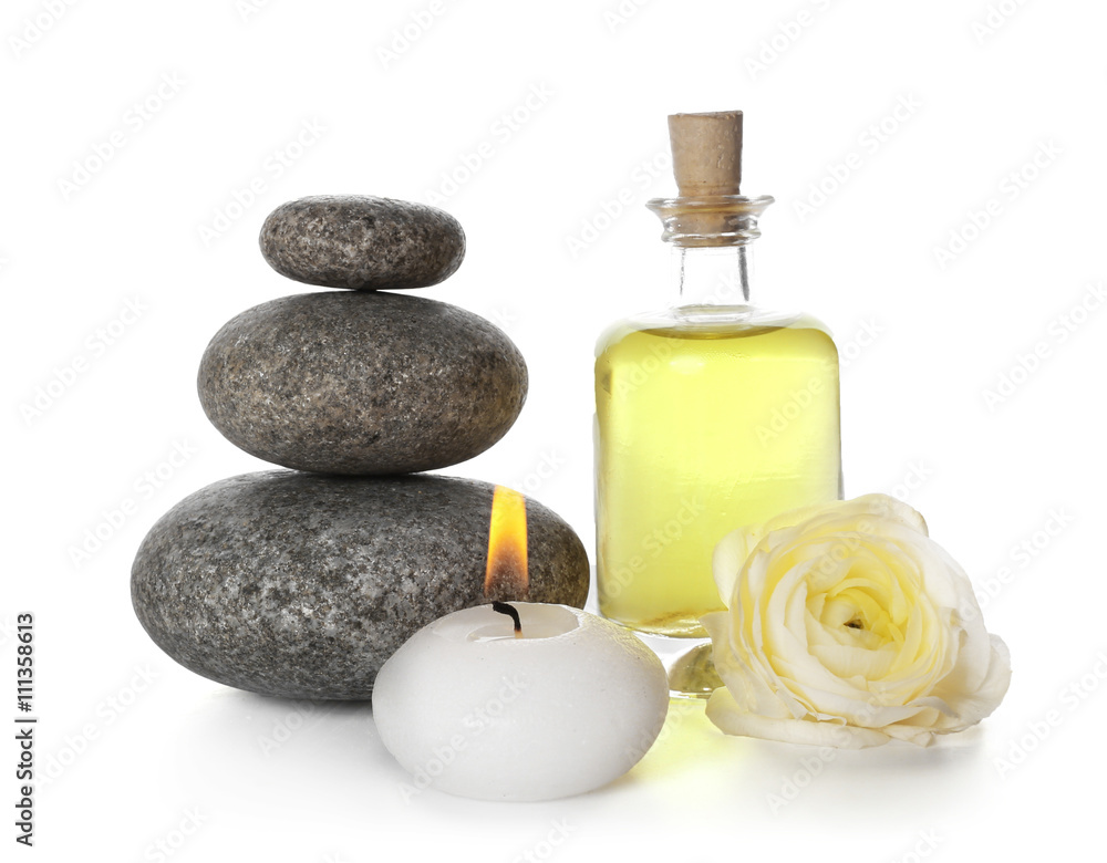 Spa still life with pebbles, oil and candle isolated on white Spa still life with pebbles, oil and candle isolated on white