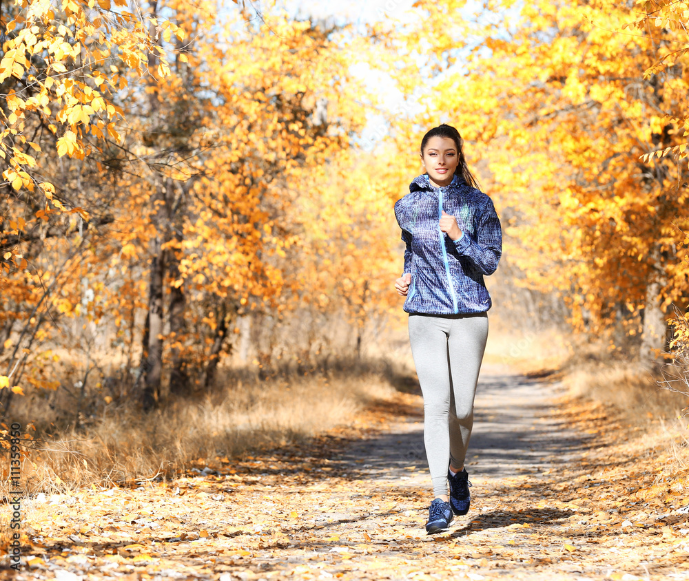 Young beautiful woman jogging in autumn park Young beautiful woman jogging in autumn park