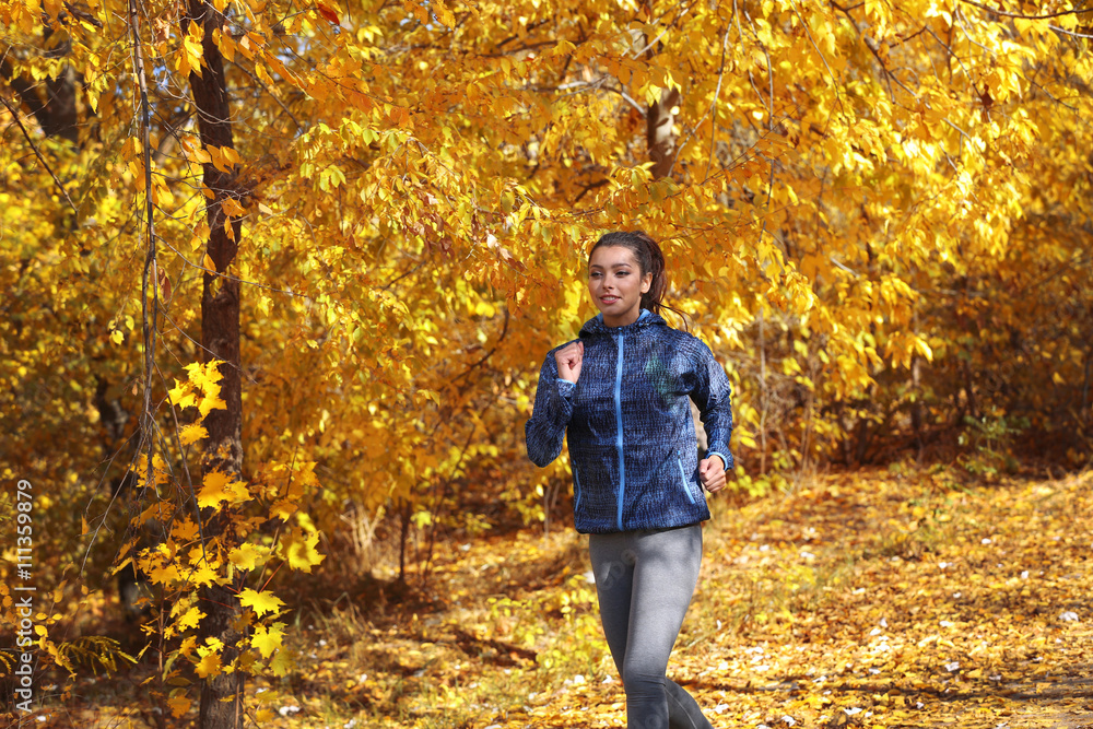 Young beautiful woman jogging in autumn park Young beautiful woman jogging in autumn park