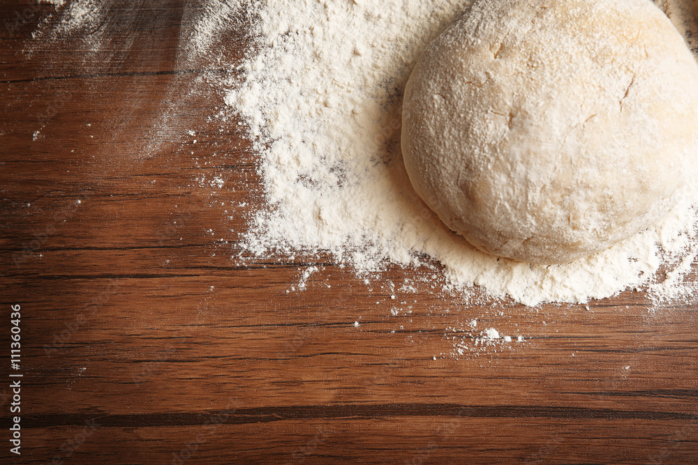Dough balls for pizza on floured wooden board Dough balls for pizza on floured wooden board