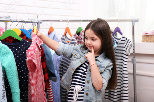 Φωτογραφία Little girl trying on a new dress